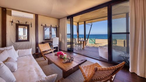 a living room with a couch and a view of the ocean at Villa Santa Cruz in Todos Santos