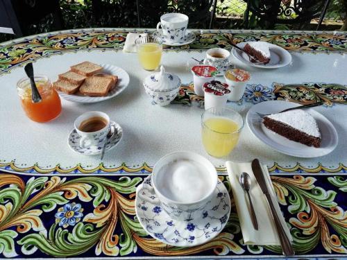 a table with a breakfast of coffee and cakes and coffee cups at La Dodicesima Luna in Triuggio