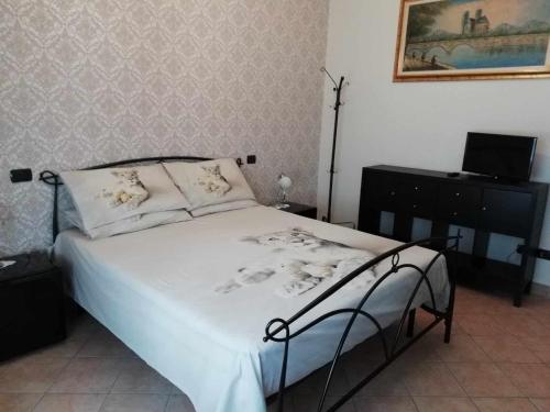 a bedroom with a bed and a laptop on a desk at La Dodicesima Luna in Triuggio