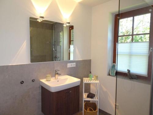a bathroom with a sink and a mirror at Holiday home gray seal in Midlum