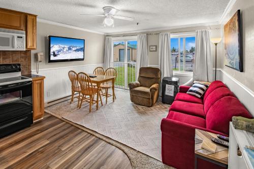 a living room with a red couch and a table at ML147 Fresh And Fun 1BR Sleeps 4 Near Village And Slopes in Dunmore