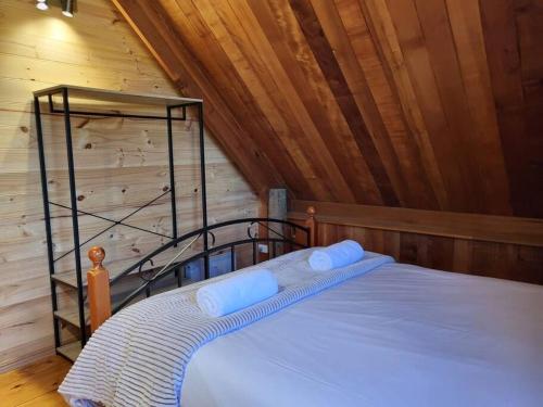 a bedroom with a bed in a wooden cabin at Mt Elephant Bush Retreat - Gray in Gray