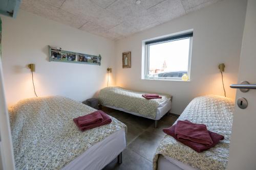 a room with two beds and a window at Sdr. Omme Bed & Breakfast in Sønder Omme