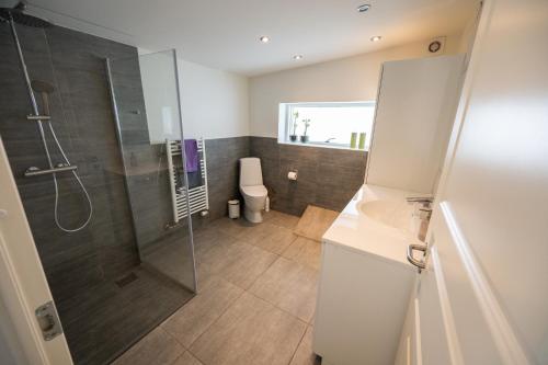 a bathroom with a shower and a glass shower stall at Sdr. Omme Bed & Breakfast in Sønder Omme