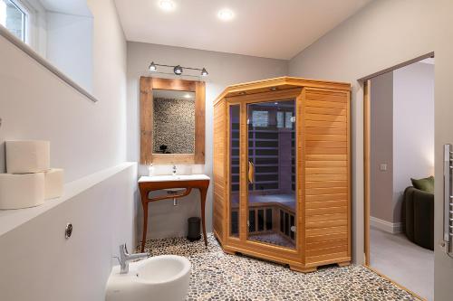 a bathroom with a wooden shower and a sink at Impressive 5Beds House in South Kensington in London
