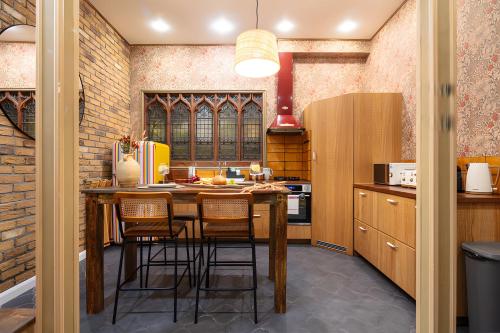 a kitchen with a table with chairs and a refrigerator at Impressive 5Beds House in South Kensington in London