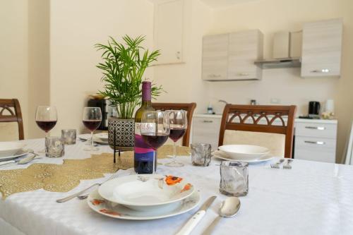 a table with glasses of wine and a plate of food at The Castle of Etna in Trecastagni