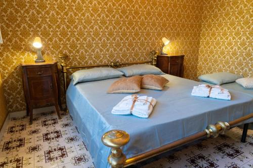 a bedroom with a bed with two towels on it at The Castle of Etna in Trecastagni