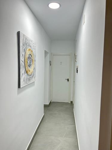 a hallway with white walls and a painting on the wall at Rooms Getafe in Getafe
