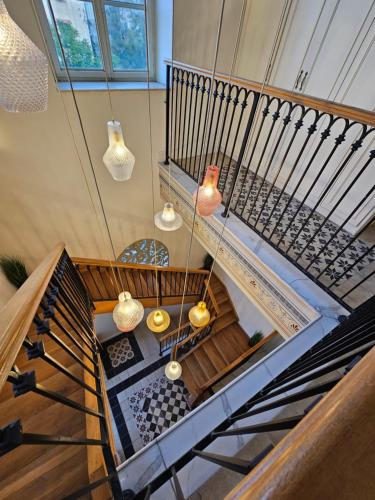 an overhead view of a staircase with pendant lights at כוהנ'ס Cohen's Boutique Hotel in Haifa