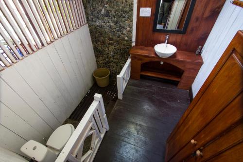 a small bathroom with a sink and a toilet at Kadidiri Paradise in Batudaka