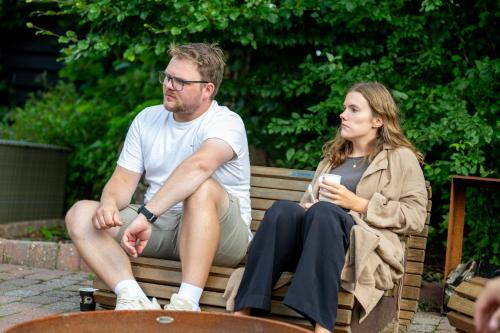 a man and a woman sitting on a bench at Sdr. Omme Bed & Breakfast in Sønder Omme