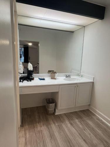 a bathroom with a sink and a large mirror at Grand Palms Spa & Golf Resort in Pembroke Pines