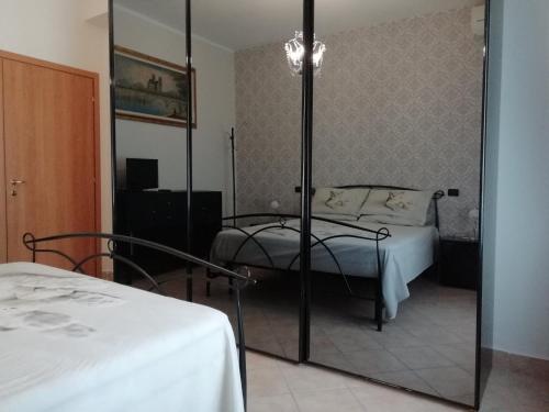 a bedroom with a bed and a mirror at La Dodicesima Luna in Triuggio