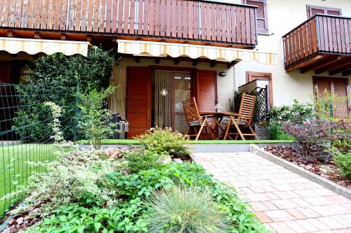 a patio with a table and chairs on a house at La casetta di Lorena in Clusone