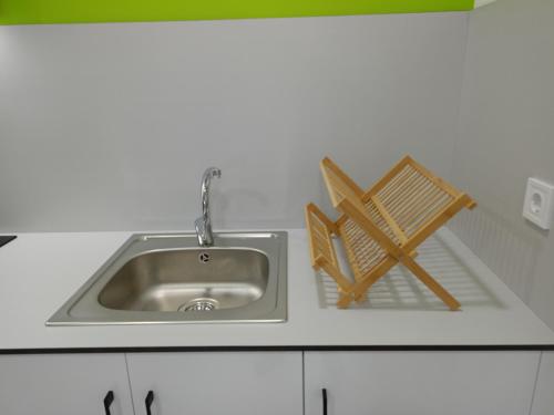 a kitchen sink with two woodenasters next to it at Apartamento Sanin 3 in Lumbrales
