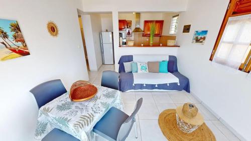 a small living room with a table and chairs at KARIFUNA in Le Souffleur