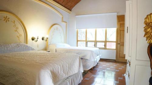 Postel nebo postele na pokoji v ubytování Hotel Ex Hacienda La Pitaya Querétaro