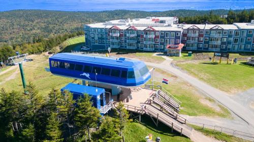 a building with a blue train on it in front of a building at ML226 1BR 1BA Slope View Close to Village Lift in Snowshoe