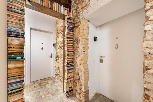 a room with a brick wall and a door with records at OLD TOWN EXPERIENCE CENTRAL Apartment in Tarragona