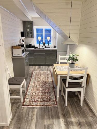 a kitchen with a table and chairs and a kitchen with a sink at Vasacenter B&B in Transtrand