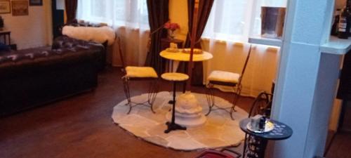 a living room with a table and stools in a room at number 8 in Leiden