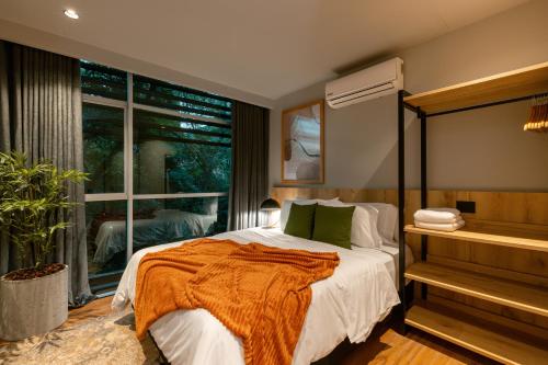 a bedroom with a bed and a large window at Spot Building - Apartments in Medellín
