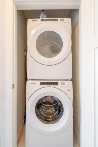 a white washer and dryer in a room at Exquisite One Bedroom Apartment in NW in Calgary