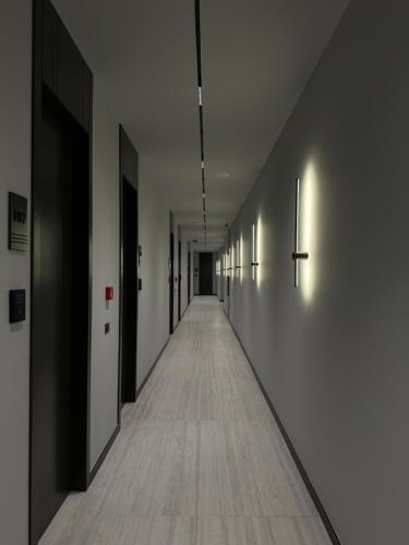 an empty hallway with black and white walls and a long aisle at The Roots Boutique Hotel in Shkodër