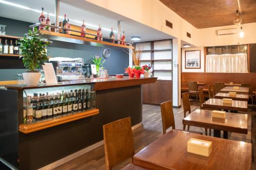 a restaurant with a bar with wooden tables and chairs at Casa Villa Gardenia Venice - Atika & Atif in Marghera