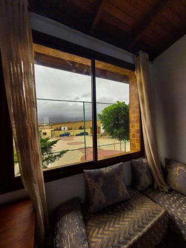 a window in a room with a couch and a view at LA GRANJA in Tetouan