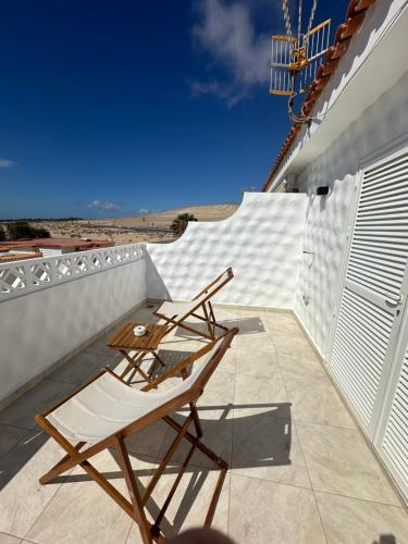 two chairs on a balcony with the ocean in the background at Casa Valen Costa Calma in Costa Calma