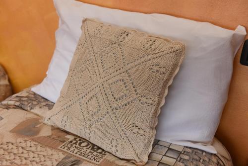 a pillow sitting on top of a bed at Casa Dante in Romano di Lombardia