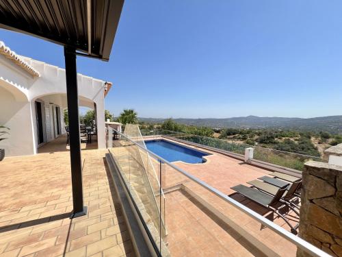 a villa with a swimming pool and a house at Algarve Premium Villa With Pool by Homing in Santa Bárbara de Nexe