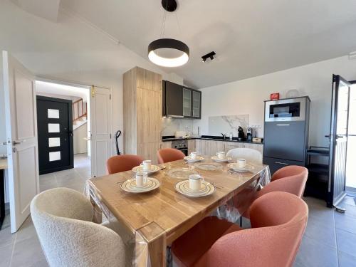 a dining room table with chairs and a kitchen at Algarve Premium Villa With Pool by Homing in Santa Bárbara de Nexe
