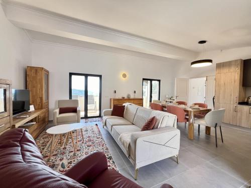 a living room with a couch and a table at Algarve Premium Villa With Pool by Homing in Santa Bárbara de Nexe