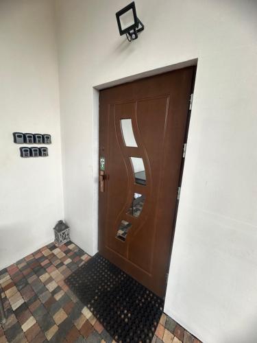 a large wooden door in a room with a tile floor at Noclegi Rybacka in Jarosław
