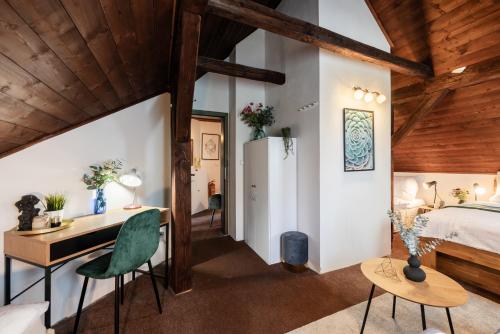 a bedroom with a bed and a desk and a table at Chata Alpina Horní Mísečky in Horni Misecky