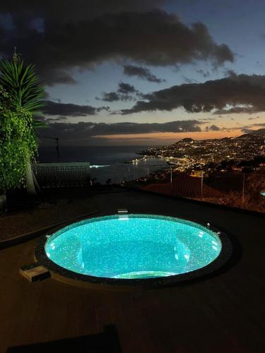a blue swimming pool on top of a building at Casa Trollis by Holiday Rental Madeira in Funchal