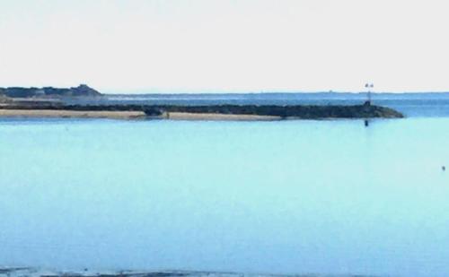 a large body of water with an island in the distance at Across from Mayo beach walk to downtown in Wellfleet