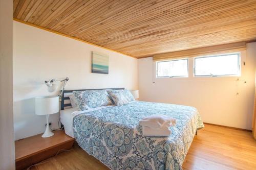 a bedroom with a bed and a wooden ceiling at National Seashore w Modern Architecture in Wellfleet