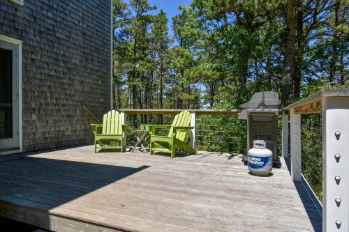 a deck with two chairs and a grill on a house at National Seashore w Modern Architecture in Wellfleet