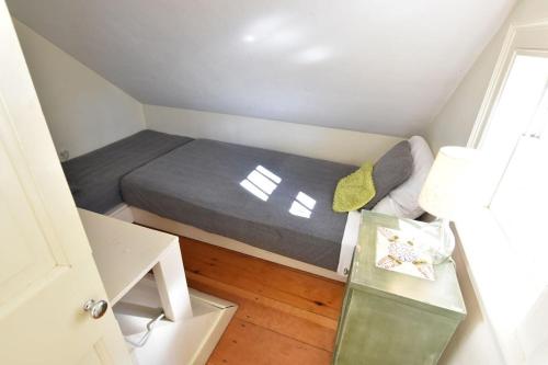 a small bedroom with a bed and a window at Heart of Brewster 5 Miles to Beach in Brewster