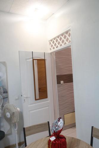 a room with a table and a door with a window at Le Moringa in Baie-Mahault