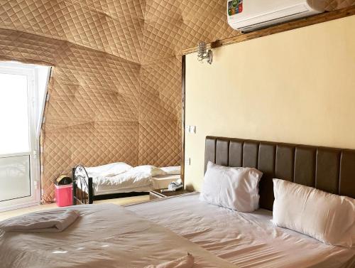 a bedroom with a bed in a room at Wadi Rum The ARC camp in Wadi Rum