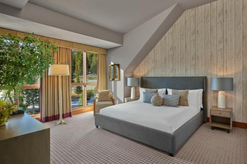 a bedroom with a bed and a large window at The Ritz-Carlton, Lake Tahoe in Truckee