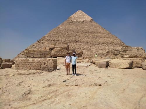two people standing in front of the pyramid at Big pyramid view house in Cairo