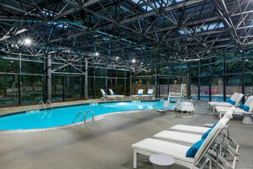 a large swimming pool with lounge chairs in a building at The Westin Atlanta Airport in Atlanta
