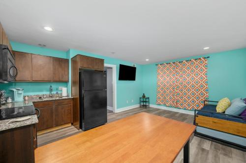 a kitchen with blue walls and a black refrigerator at Convenient 1BR Unit Close to Shopping & Dining in Houston