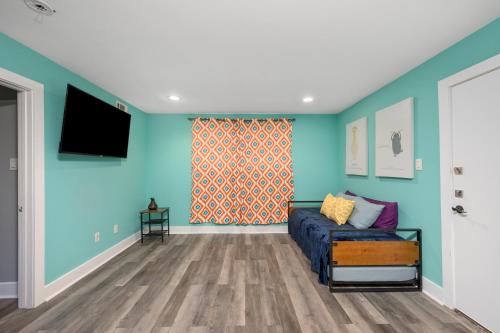 a living room with a couch and a flat screen tv at Convenient 1BR Unit Close to Shopping & Dining in Houston